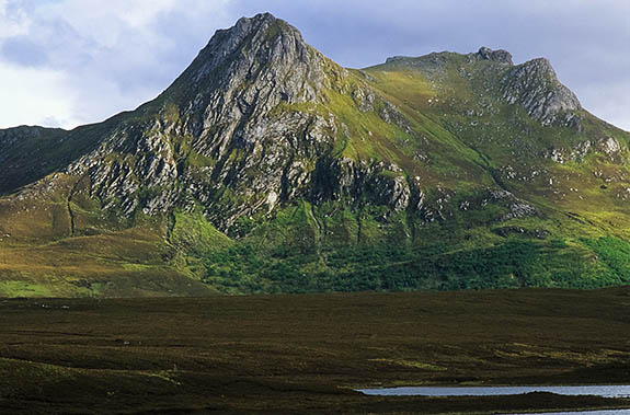 SCO: Highland Region, Sutherland District, Northern Coast, Kyle of Tongue, Ben Loyal (Ben Laoghal), 2509' peak, View over Kyle of Tongue towards Ben Loyal, bathed in late afternoon sun breaking through storm clouds [Ask for #246.775.]