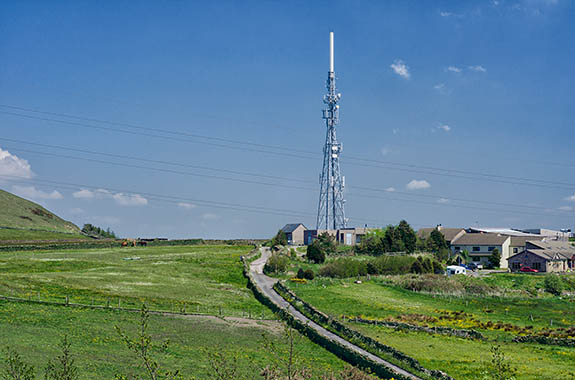ENG: The Northwest Region, Lancashire, The Pennines, Rossendale, Haslingden, Halo Panopticon, Top o' Slate Nature Reserve. View shows power lines, cell tower over a traditional Pennine farm and stone-walled lane [Ask for #270.267.]